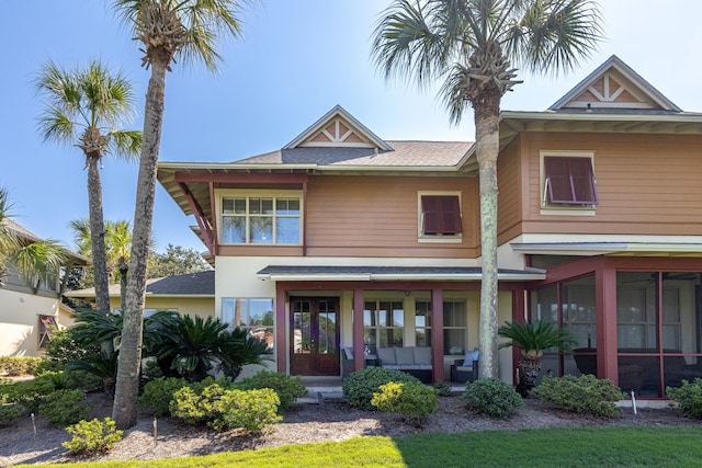 view of front of home featuring a sunroom and french doors