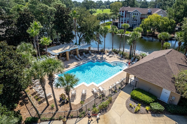 view of pool with a water view and a patio area