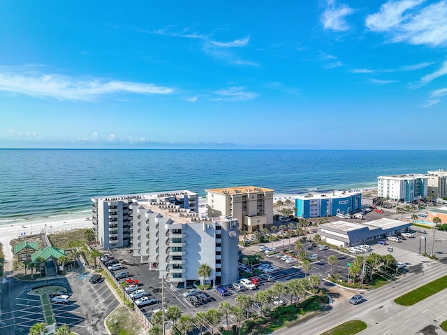 birds eye view of property with a water view and a beach view