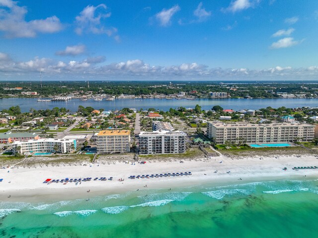 bird's eye view with a water view and a beach view