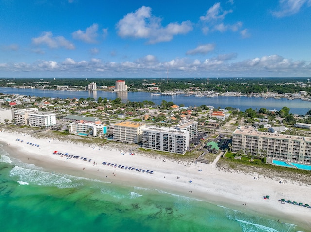 birds eye view of property with a water view and a view of the beach