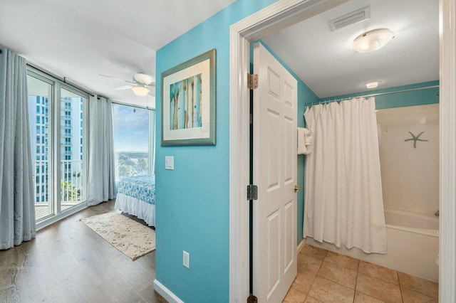 hallway with a healthy amount of sunlight and light hardwood / wood-style flooring