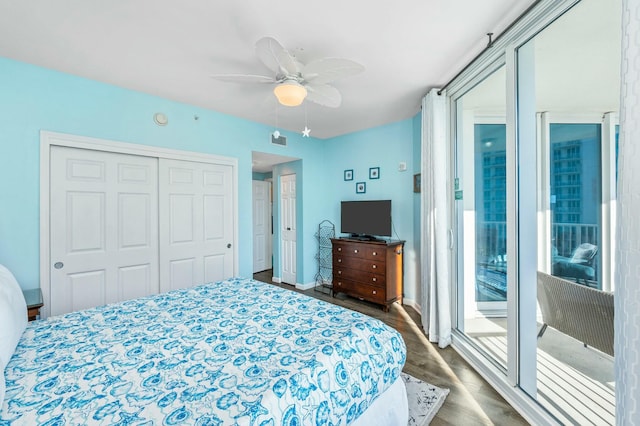 bedroom with ceiling fan, dark hardwood / wood-style floors, access to outside, and a closet