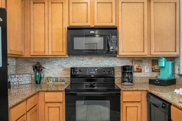 kitchen with black appliances, light stone countertops, and tasteful backsplash