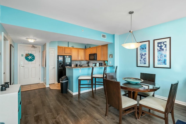 dining room with dark wood-type flooring