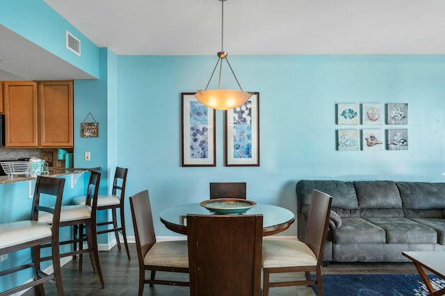 dining space with dark hardwood / wood-style floors