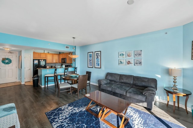 living room with dark hardwood / wood-style flooring