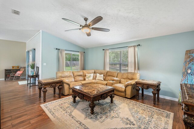 living room featuring ceiling fan, a healthy amount of sunlight, dark hardwood / wood-style flooring, and lofted ceiling