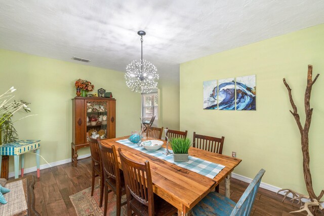 dining space featuring a chandelier and dark wood-type flooring