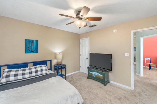 bedroom with ceiling fan and light colored carpet