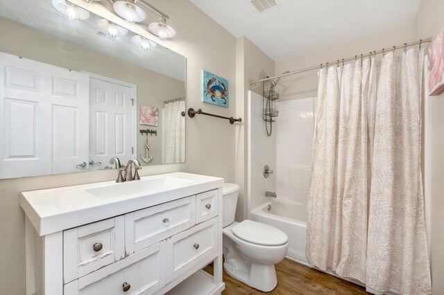 full bathroom featuring shower / bath combination with curtain, vanity, wood-type flooring, and toilet