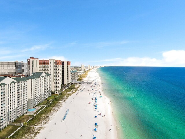 drone / aerial view featuring a water view and a view of the beach