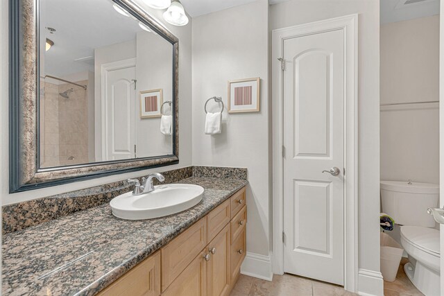 1150 Santa Rosa Blvd Unit 110, Fort Walton Beach, FL 32548 - bathroom with a tile shower, vanity, toilet, and tile patterned floors