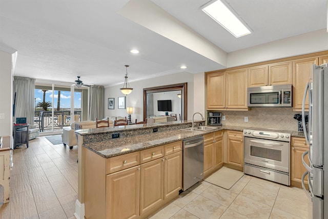 1150 Santa Rosa Blvd Unit 110, Fort Walton Beach, FL 32548 - kitchen with pendant lighting, sink, kitchen peninsula, appliances with stainless steel finishes, and dark stone counters