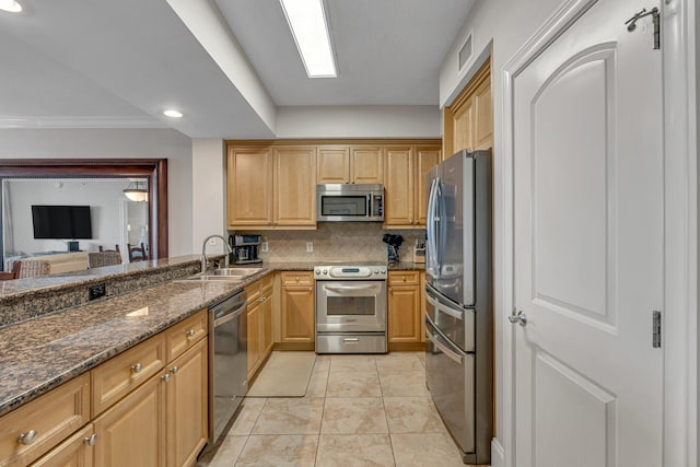 1150 Santa Rosa Blvd Unit 110, Fort Walton Beach, FL 32548 - kitchen with light tile patterned floors, sink, stainless steel appliances, dark stone countertops, and decorative backsplash