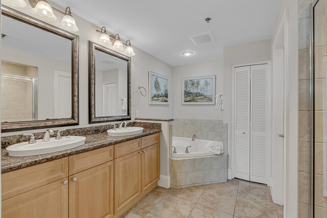 1150 Santa Rosa Blvd Unit 110, Fort Walton Beach, FL 32548 - bathroom with shower with separate bathtub, vanity, and tile patterned floors