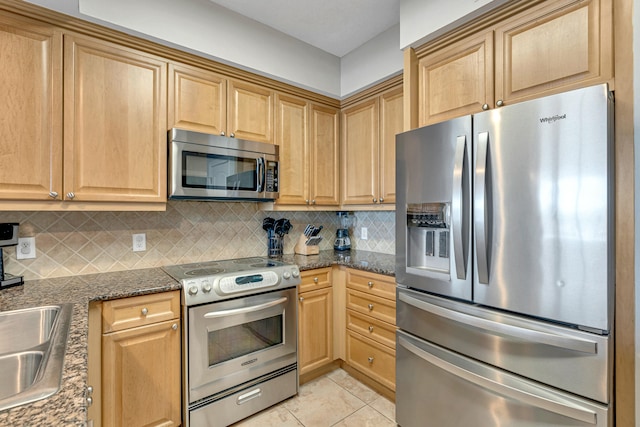 1150 Santa Rosa Blvd Unit 110, Fort Walton Beach, FL 32548 - kitchen featuring dark stone counters, tasteful backsplash, sink, stainless steel appliances, and light tile patterned floors
