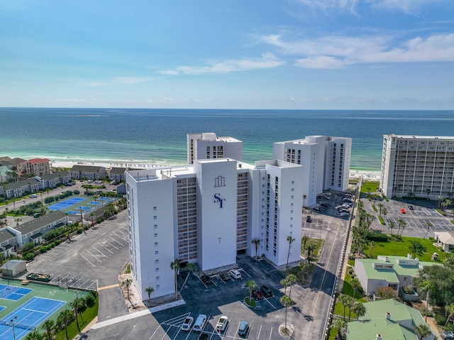 drone / aerial view featuring a water view and a view of the beach