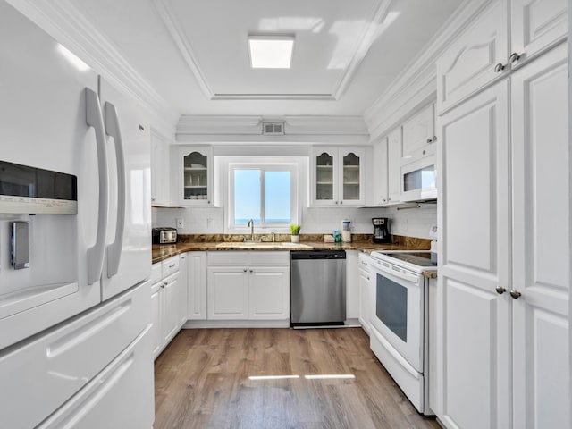 kitchen with sink, white appliances, white cabinetry, crown molding, and light hardwood / wood-style floors