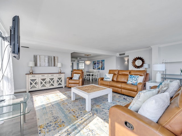 living room with light hardwood / wood-style floors and ornamental molding