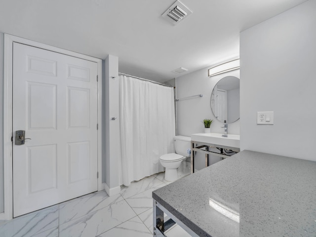 bathroom with vanity, toilet, and curtained shower