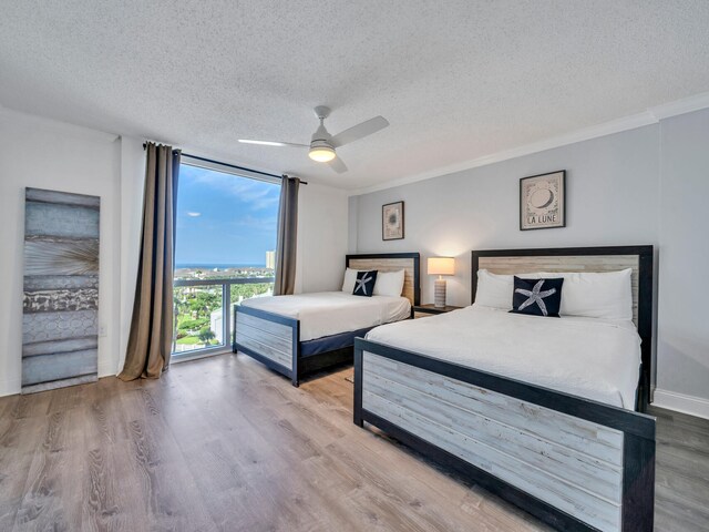 bedroom featuring ceiling fan, a textured ceiling, and wood-type flooring