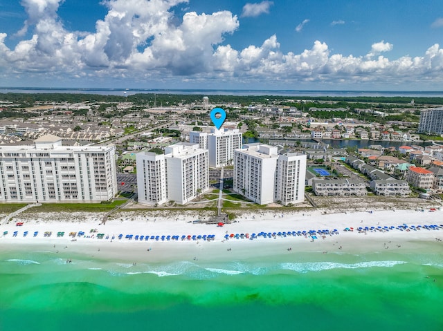 birds eye view of property with a water view and a beach view