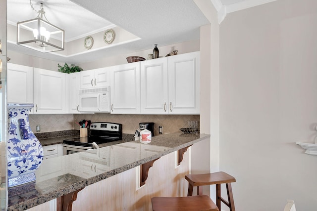 kitchen featuring a breakfast bar area, white cabinetry, hanging light fixtures, an inviting chandelier, and stainless steel electric range