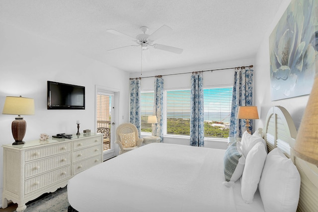 bedroom with multiple windows, a textured ceiling, and ceiling fan