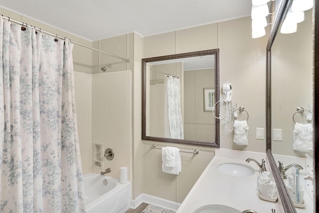 bathroom with shower / bath combo, a textured ceiling, and vanity