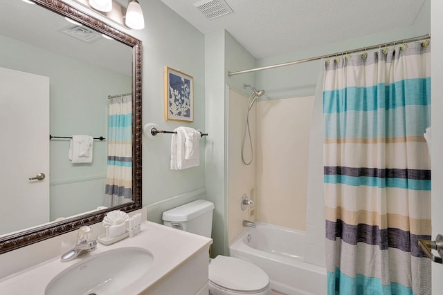 full bathroom featuring vanity, shower / bath combination with curtain, a textured ceiling, and toilet