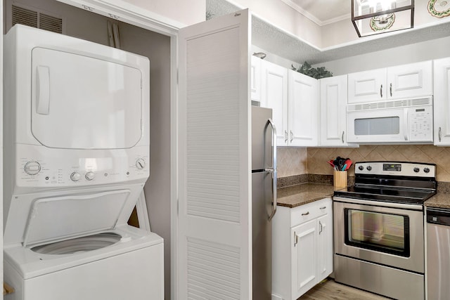 interior space featuring light hardwood / wood-style flooring and stacked washer / dryer