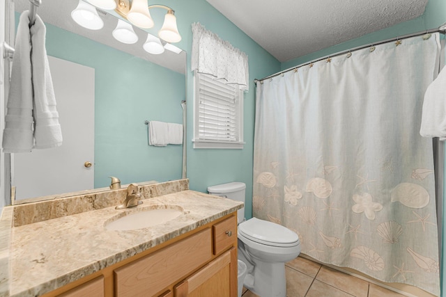 bathroom with vanity, toilet, curtained shower, a textured ceiling, and tile patterned flooring