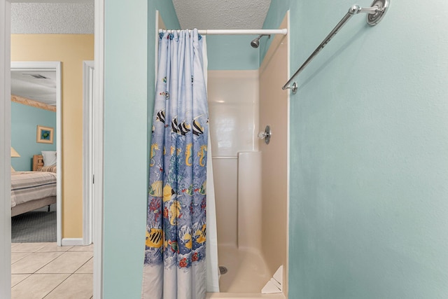 bathroom with walk in shower, a textured ceiling, and tile patterned flooring