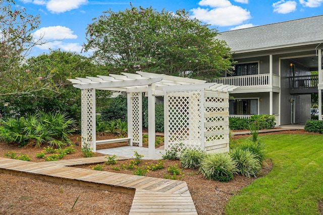 view of home's community with a lawn and a pergola