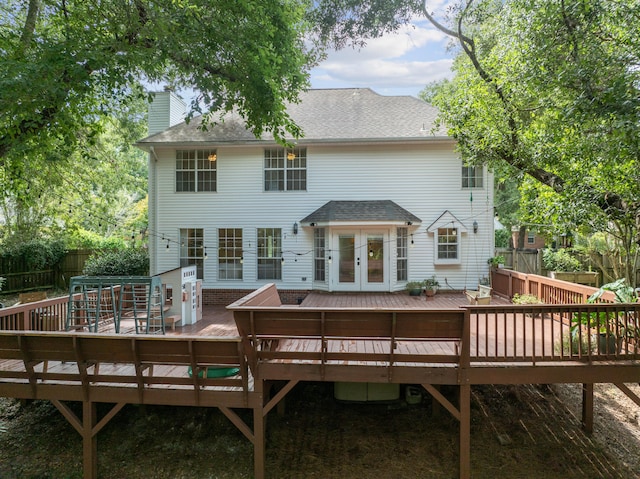 rear view of property with a deck and french doors