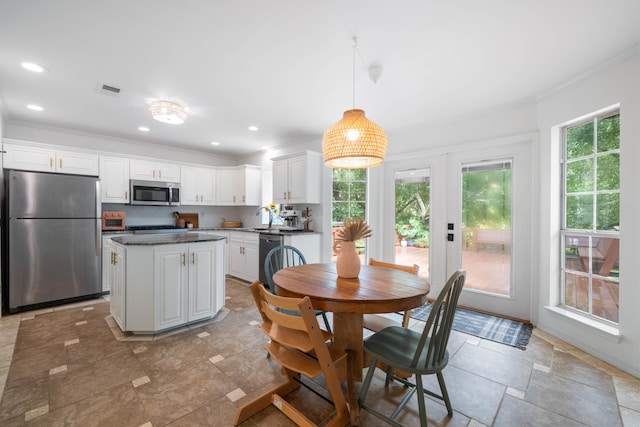 dining room with crown molding and sink