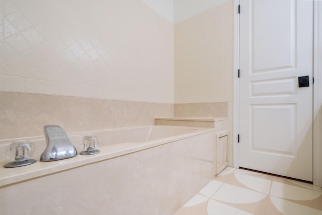 bathroom with a bathing tub and tile patterned floors