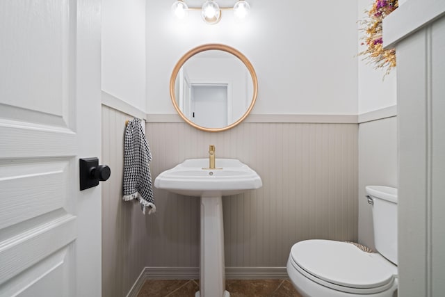 bathroom with tile patterned flooring and toilet