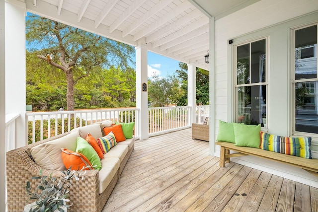 sunroom / solarium featuring beamed ceiling