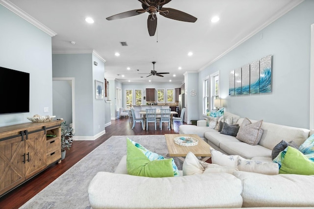 living room with dark hardwood / wood-style flooring, ceiling fan, and crown molding