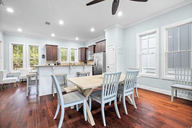 dining room with dark hardwood / wood-style floors, ceiling fan, and ornamental molding