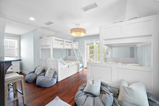 bedroom with dark hardwood / wood-style flooring