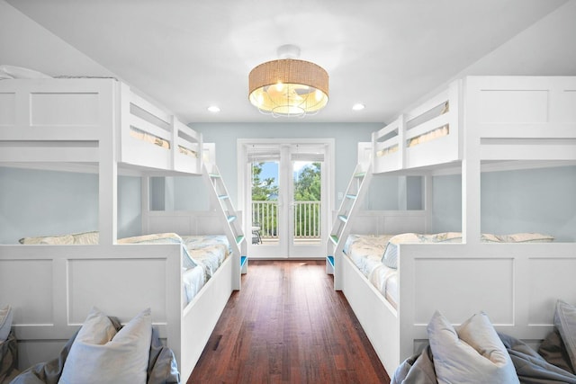 bedroom with access to outside and dark wood-type flooring