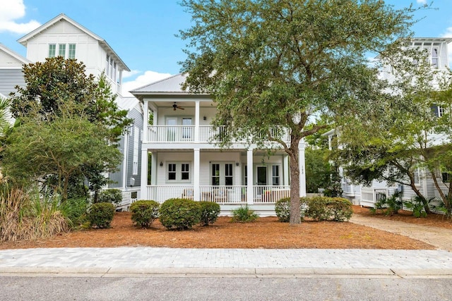 view of front of property featuring ceiling fan, a balcony, and a porch