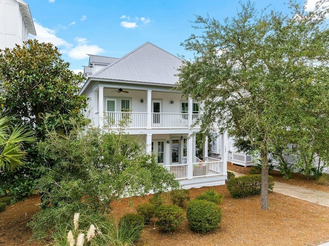 view of front of property featuring ceiling fan, a balcony, and covered porch