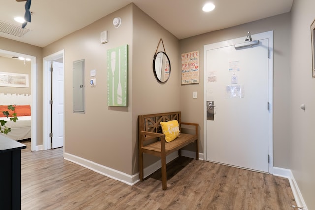 entryway with light hardwood / wood-style flooring and electric panel