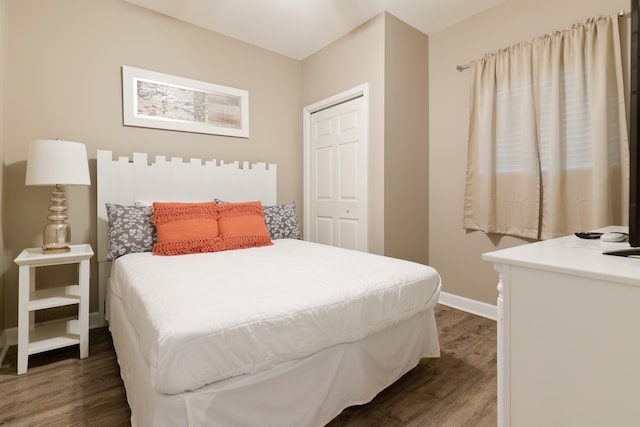 bedroom with a closet and dark wood-type flooring