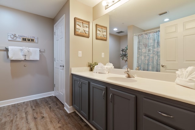 bathroom featuring vanity and hardwood / wood-style flooring