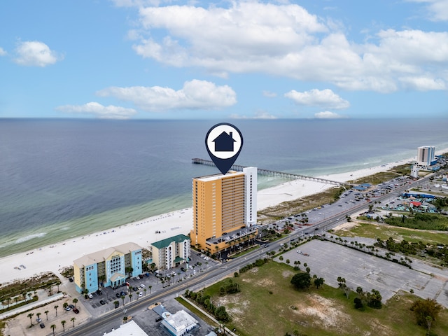 bird's eye view with a water view and a beach view